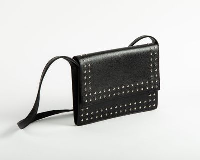 a black leather purse with rivets and a strap