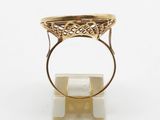 a close up of a gold ring on a white surface