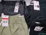 two pairs of pants and a sweater on a table