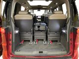 two seats in the back of a van with luggage in the back