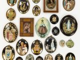 an image of a collection of decorative plates and pictures on a wall