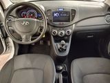 the interior of a small car with a steering wheel and dashboard