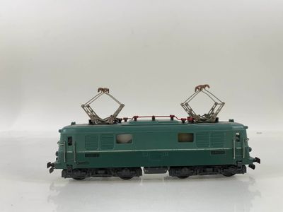 a green train on a white surface with a white background