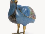 an image of a blue and gold bird figurine on a white background