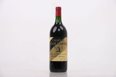 a bottle of red wine sitting on top of a white table