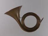 a brass instrument hanging from the ceiling in the room