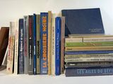 many books that are stacked on a shelf together
