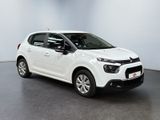 a white citrole is parked in a white room