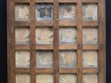 an old wooden display case with a lot of glass in it
