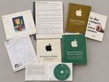 many books and cds on the table with an apple logo