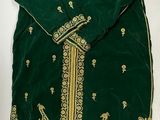 an image of a green and gold dress with a bird on it