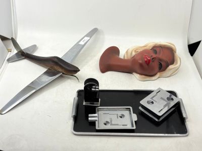 a picture of a woman ' s face and a pair of scissors on a tray