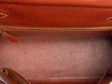 the inside of a brown purse with a zipper on it