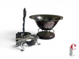 a silver bowl and a silver spoon on a stand