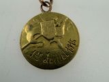 a close up of a gold coin with a cat on it