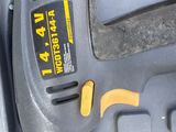 a cordless drill in a tool box with a tool in it