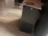 a computer on the floor under a desk in a room