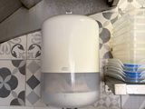 a water dispenser in the corner of a kitchen