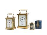 several different types of clocks are displayed on a white surface