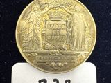 une image d'une pièce d'or sur laquelle figure l'État de New York