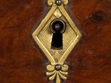 a close up of a wooden box with a keyhole