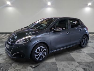 a grey car is parked in a large room with checkered floor