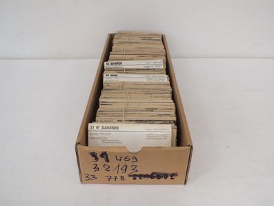une boîte en carton ouverte remplie d'une pile de vieux disques