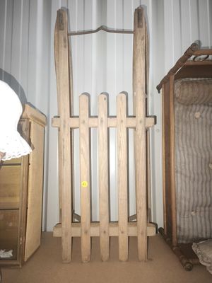 a wooden gate next to a bed in a room