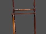 an old wooden coat rack with a coat hanger on top of it