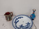 a blue and white bowl and a blue and white plate on a white table