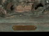 a bronze statue of a man and a dog on a bench