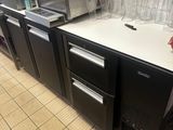 a kitchen with a sink and a refrigerator in it