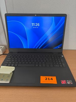a laptop that is sitting on a desk next to a phone