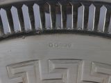 a close up of a silver plate with a design on it