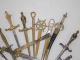 a lot of different types of swords on the table