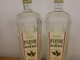 two bottles of liquor sitting on top of a wooden table