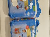 two bags of diapers sitting on top of each other