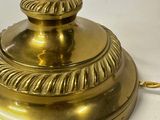 a gold lamp that is on a white table