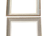 two white picture frames sitting next to each other on a white surface