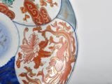 a close up of a decorative plate with flowers on it