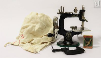 a small sewing machine with a cloth bag on the table