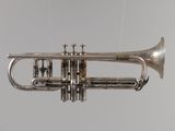 a silver trumpet that is hanging from the ceiling