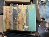 a box of books sitting on a table next to a cd