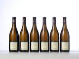 six bottles of wine are lined up on a table