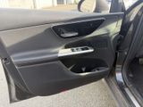 the door of a car is open with the driver ' s side door open