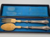 two forks and a spoon in a blue box