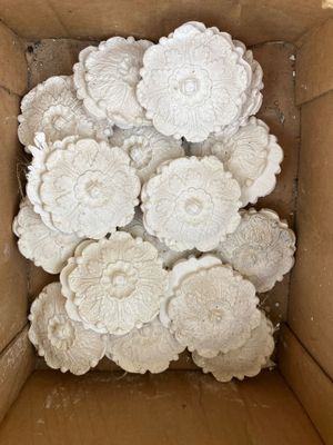 a cardboard box with a bunch of white flowers inside of it