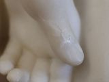 a close up of a statue of a person ' s hands