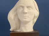 sculpture of a woman ' s head on a marble base