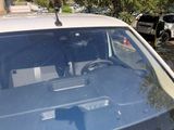 a car that is parked in a lot with a broken windshield